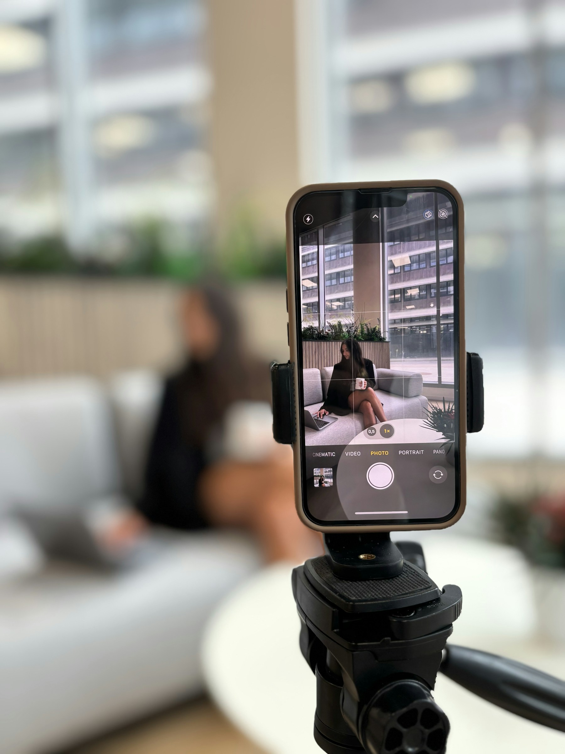 Smartphone recording a woman on a couch